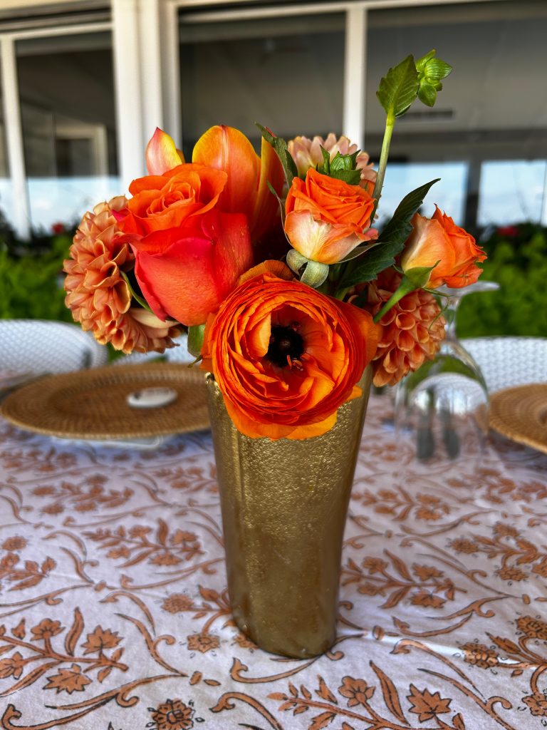 Small floral table arrangement in orange tones